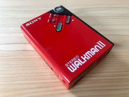 Excellent condition, fully functional Sony WM-2 holder & new headphones.