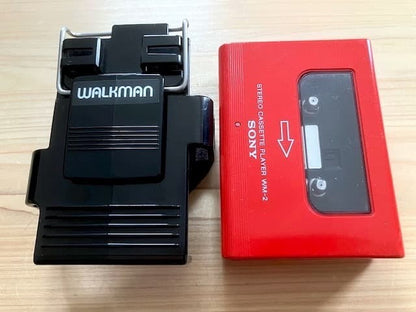 Excellent condition, fully functional Sony WM-2 holder & new headphones.