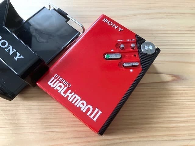 Excellent condition, fully functional Sony WM-2 holder & new headphones.