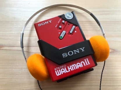 Excellent condition, fully functional Sony WM-2 holder & new headphones.