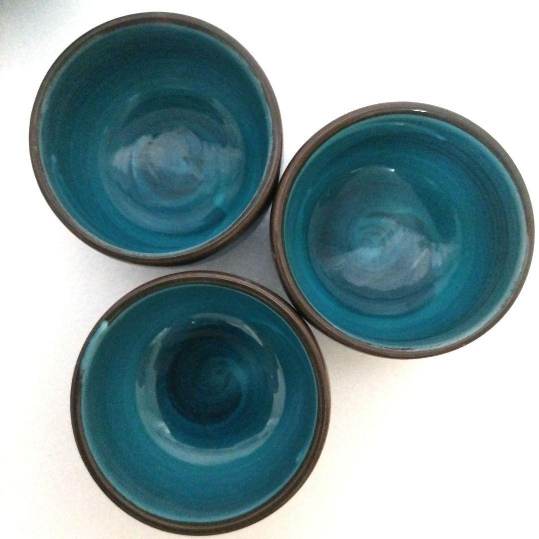 Turquoise blue ceramic sake set. One sake bottle, three tea cups.