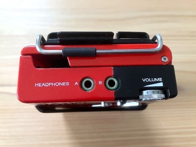 Excellent condition, fully functional Sony WM-2 holder & new headphones.