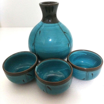 Turquoise blue ceramic sake set. One sake bottle, three tea cups.